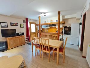 eine Küche und ein Esszimmer mit Tisch und Stühlen in der Unterkunft Le Saint M, T3, wifi, parking, jardin, Saint Mamet in Saint-Mamet + 21 Fotos
