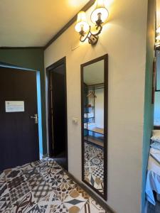a mirror on a wall next to a bedroom at La Livada in Otopeni