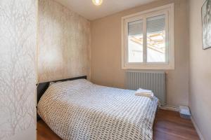 ロワイヤンにあるLa Petite Maison de Royanのベッドと窓のある寝室