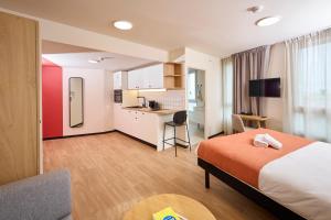 a hotel room with a bed and a kitchen at Hife Vélizy in Vélizy-Villacoublay +52 photos