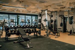 a gym with several rows of tread machines at AQUA RESORT by Bel Mare in Międzyzdroje