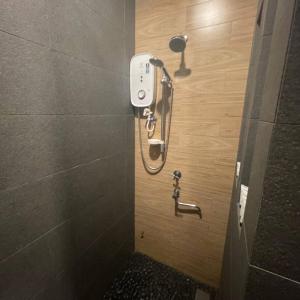 a shower in a bathroom with a tile wall at Perhentian Arwana-Resort Bs in Pulau Perhentian Besar