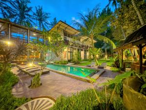an exterior view of a house with a swimming pool at Gunung An Retreat in Ubud