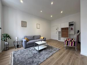 a living room with a couch and a table at Bright studio - great for a stay in Ecully in Écully