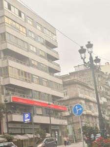a tall building with a street sign in front of it at Vigo Central Retreat in Vigo