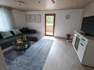 a living room with a couch and a table at Ark Runa in Metten