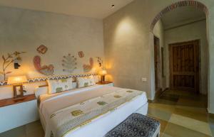 a bedroom with a large bed in a room at Tehla Bagh in Tehla