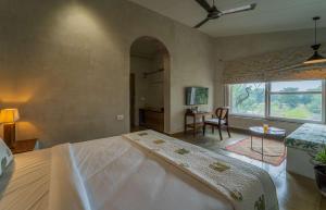 a bedroom with a large bed and a window at Tehla Bagh in Tehla