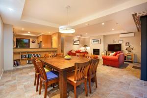 a living room with a wooden table and chairs at Sea Vista - Beachside Resort-style Bliss in Broadwater
