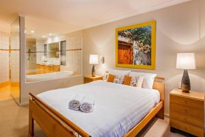 a bedroom with a large bed and a bath tub at Sea Vista - Beachside Resort-style Bliss in Broadwater +29 photos