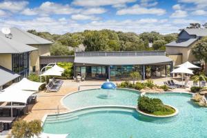 a large swimming pool with a fountain in front of a building at Sea Vista - Beachside Resort-style Bliss in Broadwater