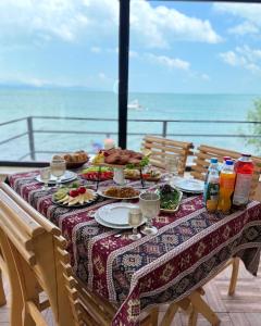 a table with food on it with a view of the ocean at Sea Star in Sevan