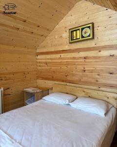 a bedroom with a bed in a wooden cabin at Sea Star in Sevan