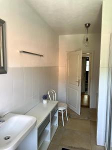 a bathroom with a sink and a white counter at Apartment Siggi 81 sqm Balcony and Mountain View in Siegsdorf +12 photos