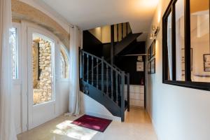 a hallway with a blue staircase in a house at L'appartement de la mouline avec domaine privée in Pézenas