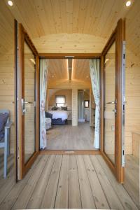 a room with a door open to a bedroom at Luxury Glamping Pod - Garthside Farm Holidays in Brampton
