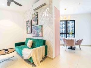 a living room with a green couch and a table at Paxtonz Luxe Suites - Damansara - PJ - by The Stay Hub in Kampong Bukit Lanjan