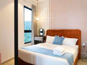 a bedroom with a bed with blue and white pillows at Paxtonz Luxe Suites - Damansara - PJ - by The Stay Hub in Kampong Bukit Lanjan +66 photos