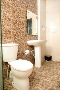 a bathroom with a toilet and a sink at Hotel De Agya Paradise in Ludhiana