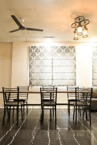 a row of chairs in a room with a ceiling fan at Hotel De Agya Paradise in Ludhiana