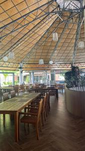 a large dining room with wooden tables and chairs at Perhentian Arwana-Resort Bs in Pulau Perhentian Besar