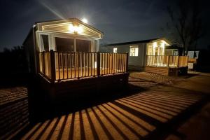 a house with a light on the porch at night at 3-Bed Lodge Sleeps 6 Hot tub in Preston