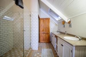a bathroom with a sink and a glass shower at Sea Pearl Holiday Home in Paternoster +26 photos
