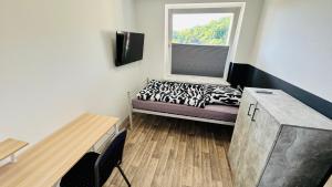a small room with a bed and a window at Apartment Osnabrück Haste in Osnabrück