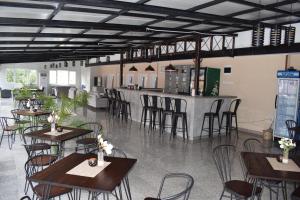 a restaurant with tables and chairs and a bar at Tintyava Balneohotel in Varshets