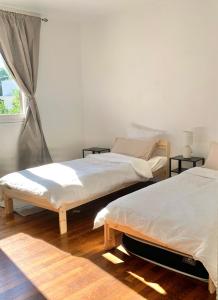 ヴィリー・シャティヨンにあるCharming Home with Garden and Terrace near Parisの窓のある部屋にツインベッドが2台