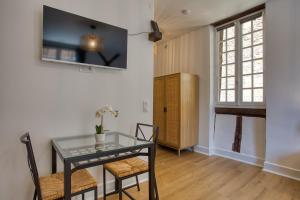 a dining room with a glass table and chairs at STUDIO ECUYER centre historique in Sarlat-la-Canéda