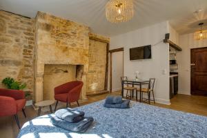 a room with a bed and a table with chairs at STUDIO ECUYER centre historique in Sarlat-la-Canéda