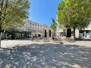 a group of tables and chairs in a city square at Havana Club - Numéro 1 in Niort