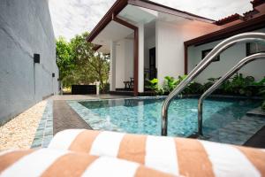 a swimming pool in the backyard of a house at Villa Zenora Hikkaduwa in Hikkaduwa