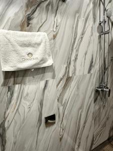 a shower with a white towel on the wall at Chantrer in Burgas +74 photos