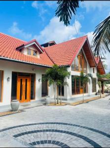 a house with a red roof and a courtyard at Turtle bay view private villa in Liyanegoda