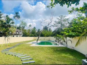a swimming pool in the yard of a house at Turtle bay view private villa in Liyanegoda