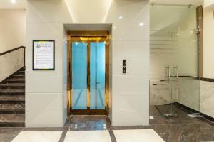 a elevator in a building with a glass door at Treebo Premium Gateway Triveni in Prayagraj