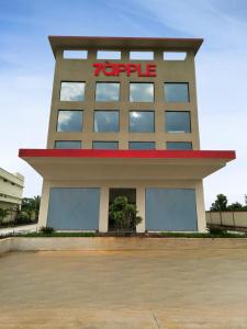 a building with a sign on the top of it at 7 Apple Hotel Vizag, Visakhapatnam in Dāpuri