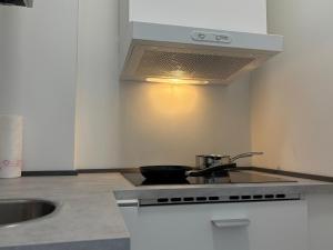 a kitchen with a sink and a stove top oven at City Line Koblenz in Koblenz