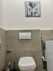 a bathroom with a toilet and a newspaper on the wall at City Line Koblenz in Koblenz