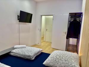 a room with a bed and a tv on a wall at City Line Koblenz in Koblenz