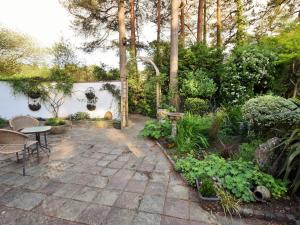 a patio with a table and chairs in a garden at 1 Bed in Ashley Heath 50147 in Saint Ives