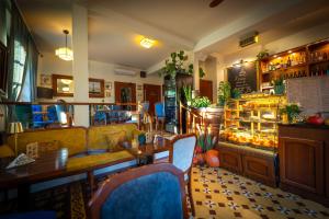 a restaurant with a table and chairs and a counter at Agharta in Kazimierz Dolny