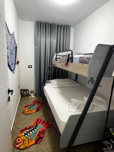 a bunk bed room with two bunk beds in it at Lighthouse Apartaments Shengjin in Shëngjin