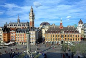 a city with a clock tower and a building at Suite Balnéo Privée Design Calme Proche Lille in Roubaix