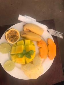 a plate of fruit and vegetables on a table at NEW ORANGE APARTMEnt in Jambiani