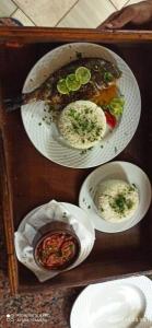 three plates of food in a wooden tray at Mishmish wood house in Nuweiba +15 photos