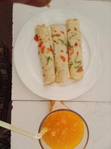 a white plate with four pieces of food on it at NEW ORANGE APARTMEnt in Jambiani +22 photos