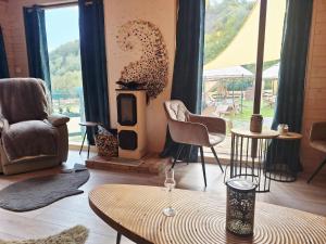 a living room with chairs and a wood stove at Apartmán na detskej zážitkovej farme Fajnovô in Nová Baňa